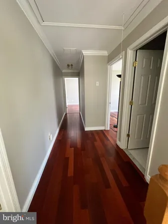 a view of hallway with wooden floor