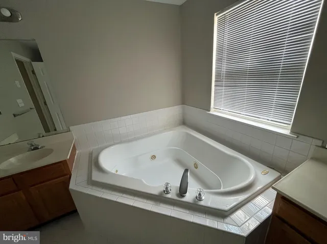 a bath tub sitting in a bathroom next to a window
