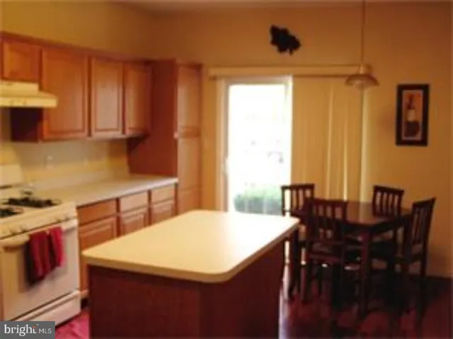 a kitchen with a table chairs and a window