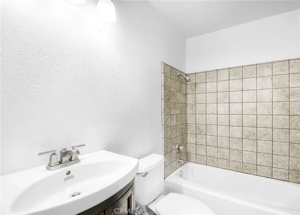 a bathroom with a bathtub and sink