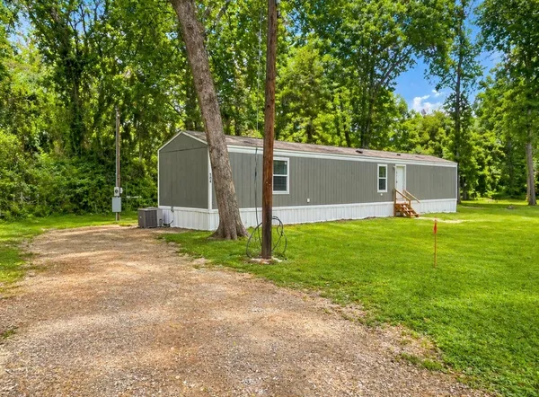 a front view of house with yard and trees