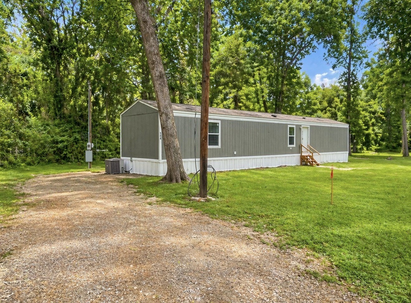 a front view of house with yard and trees