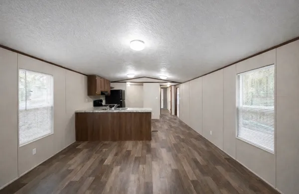 a view of a room with wooden floor and windows