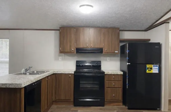 a kitchen with a refrigerator and a stove