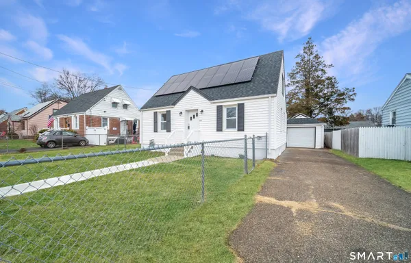 a front view of house with yard and green space