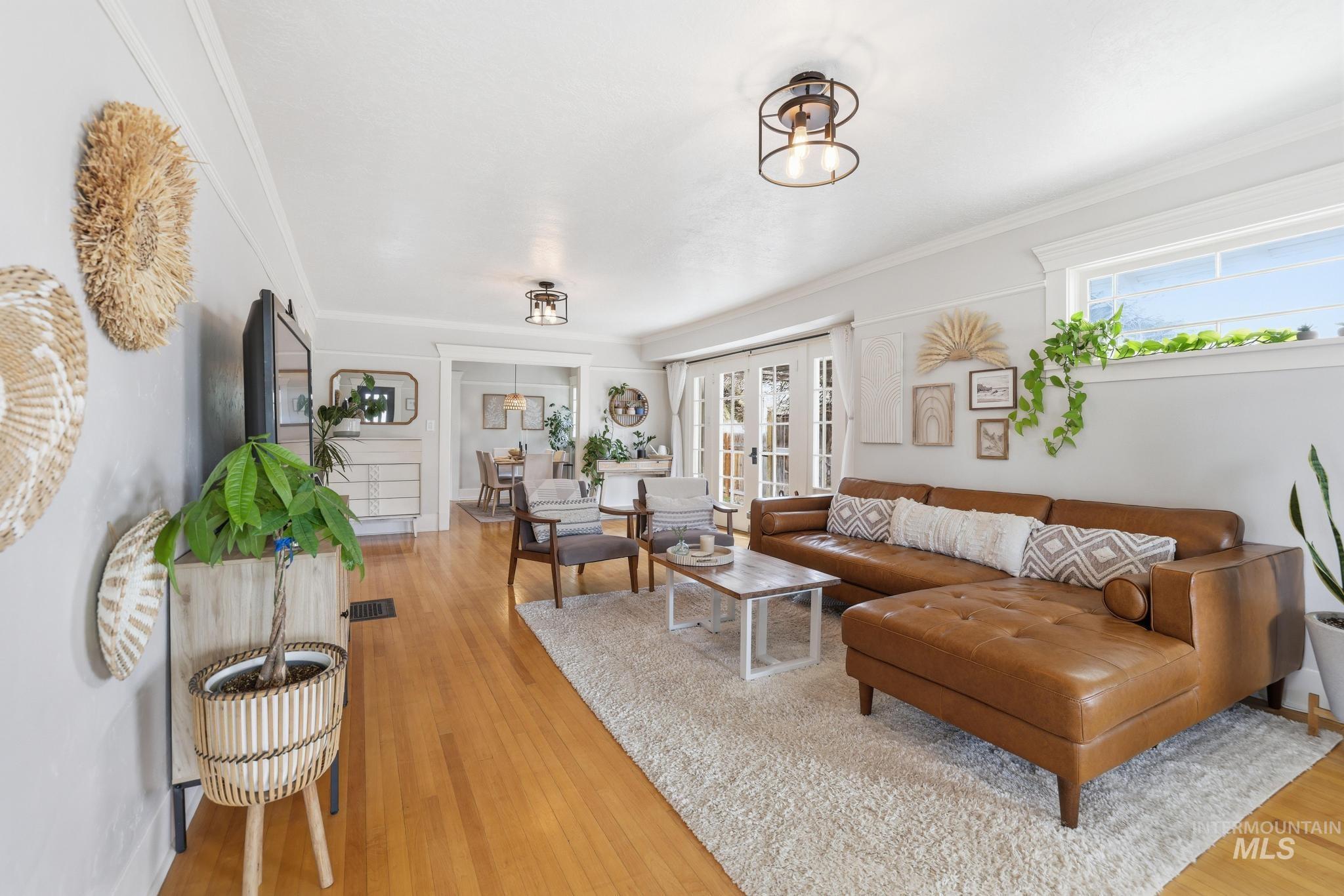 502 6th Street Filer, ID 83328 - Photo 5 of 41 Living room with light wood finished floors, ornamental molding, and french doors