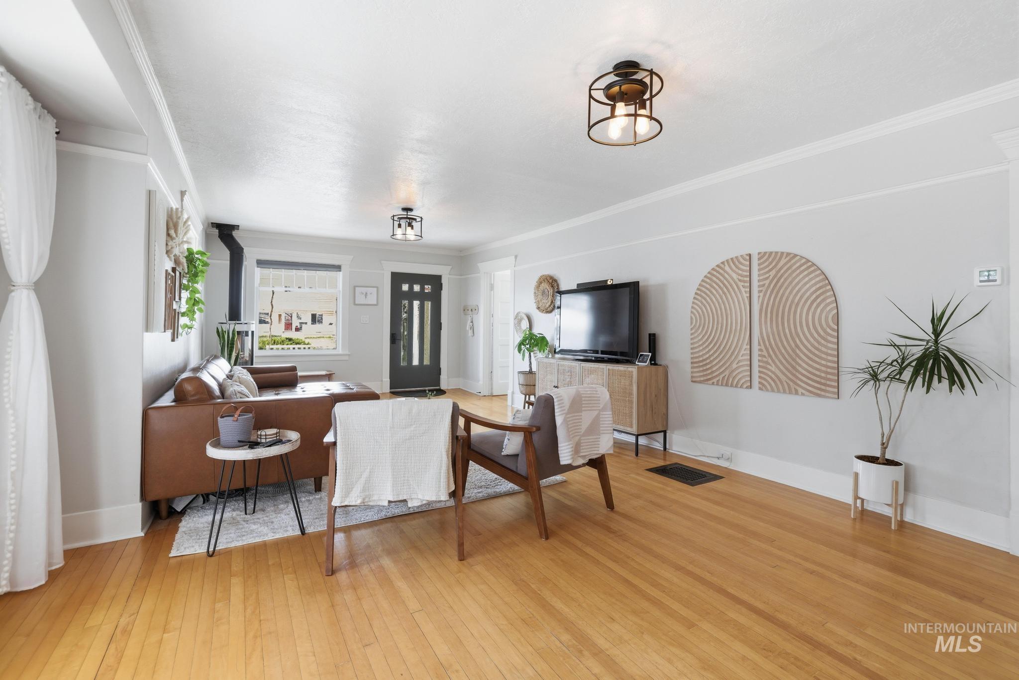 502 6th Street Filer, ID 83328 - Photo 7 of 41 Living area featuring light wood finished floors and crown molding