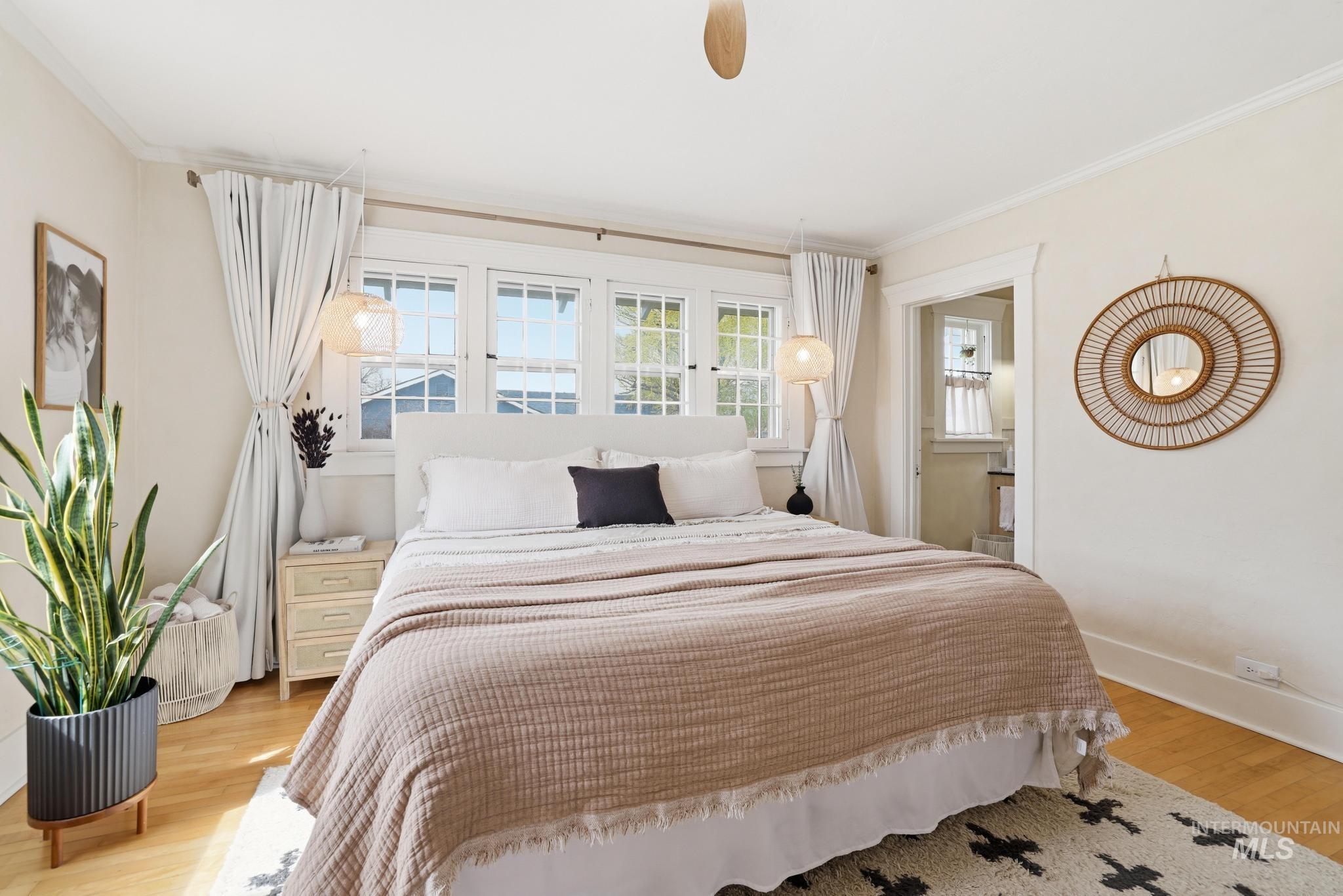 502 6th Street Filer, ID 83328 - Photo 9 of 41 Bedroom featuring light wood-style flooring, ornamental molding, ceiling fan, and ensuite bath