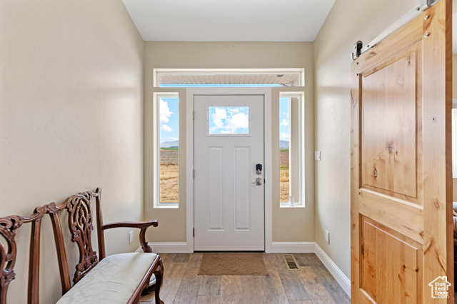 19502 South Olson Road Downey, ID 83234 - Photo 7 of 64 Foyer featuring a barn door and light wood finished floors