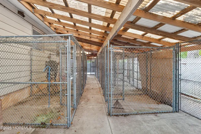 a view of backyard space with wooden fence