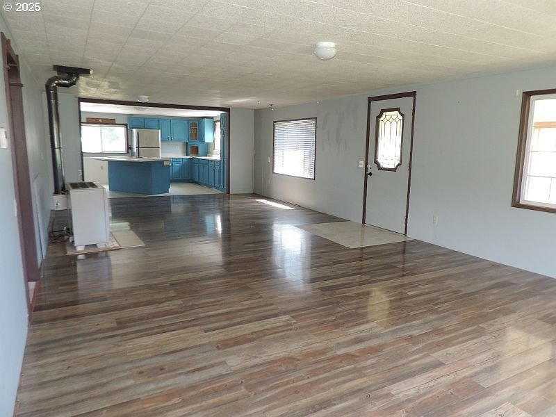 1525 Highway 97 Goldendale, WA 98620 - Photo 15 of 46 an empty room with wooden floor and windows