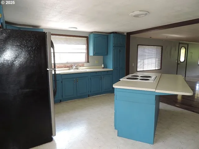 a kitchen that has a sink and a stove in it