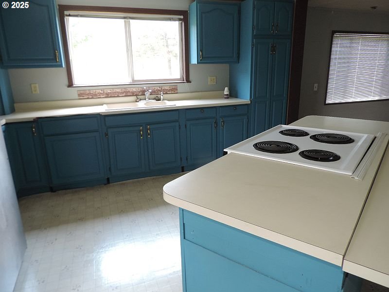 1525 Highway 97 Goldendale, WA 98620 - Photo 18 of 46 a kitchen with a sink a stove and wooden cabinets