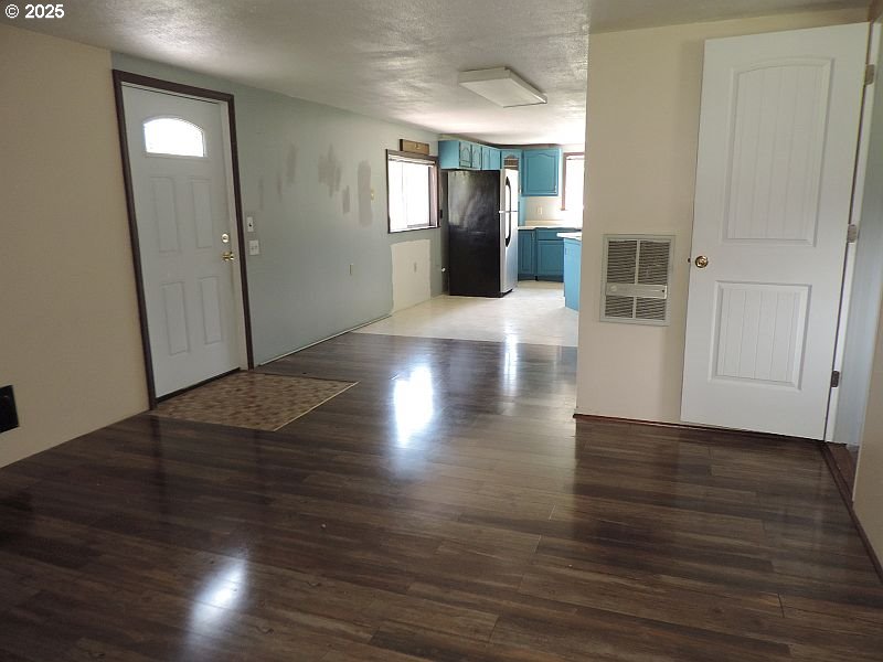 1525 Highway 97 Goldendale, WA 98620 - Photo 21 of 46 an empty room with wooden floor and windows