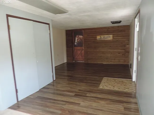 a view of hallway with wooden floor