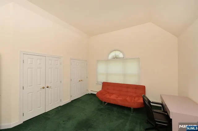 a room with a chair and potted plant