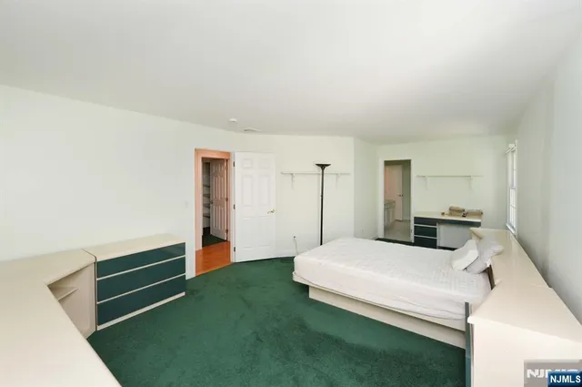 a bedroom with a bed and cabinets