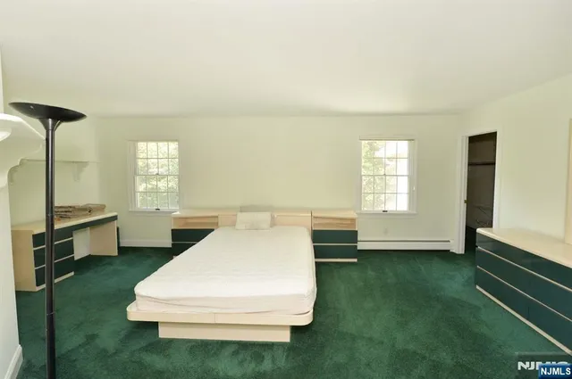 a bathroom with a sink a toilet and a window