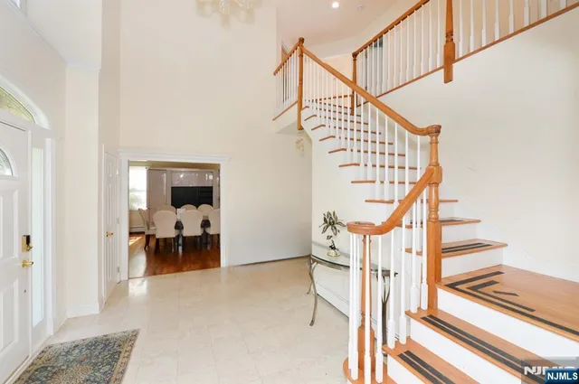 a view of entryway dining room and hall with wooden floor