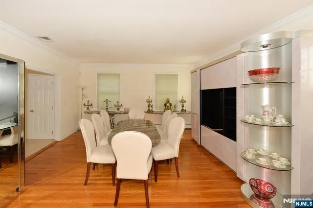 a dining room with furniture and wooden floor