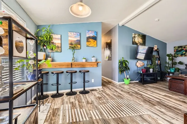 a bedroom with furniture and a wooden floor