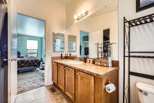 a en suite bathroom with a sink a mirror and shower