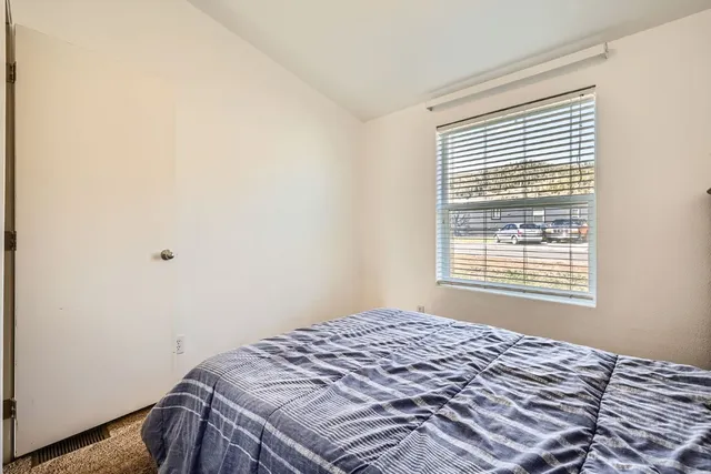 a bedroom with a bed and a window