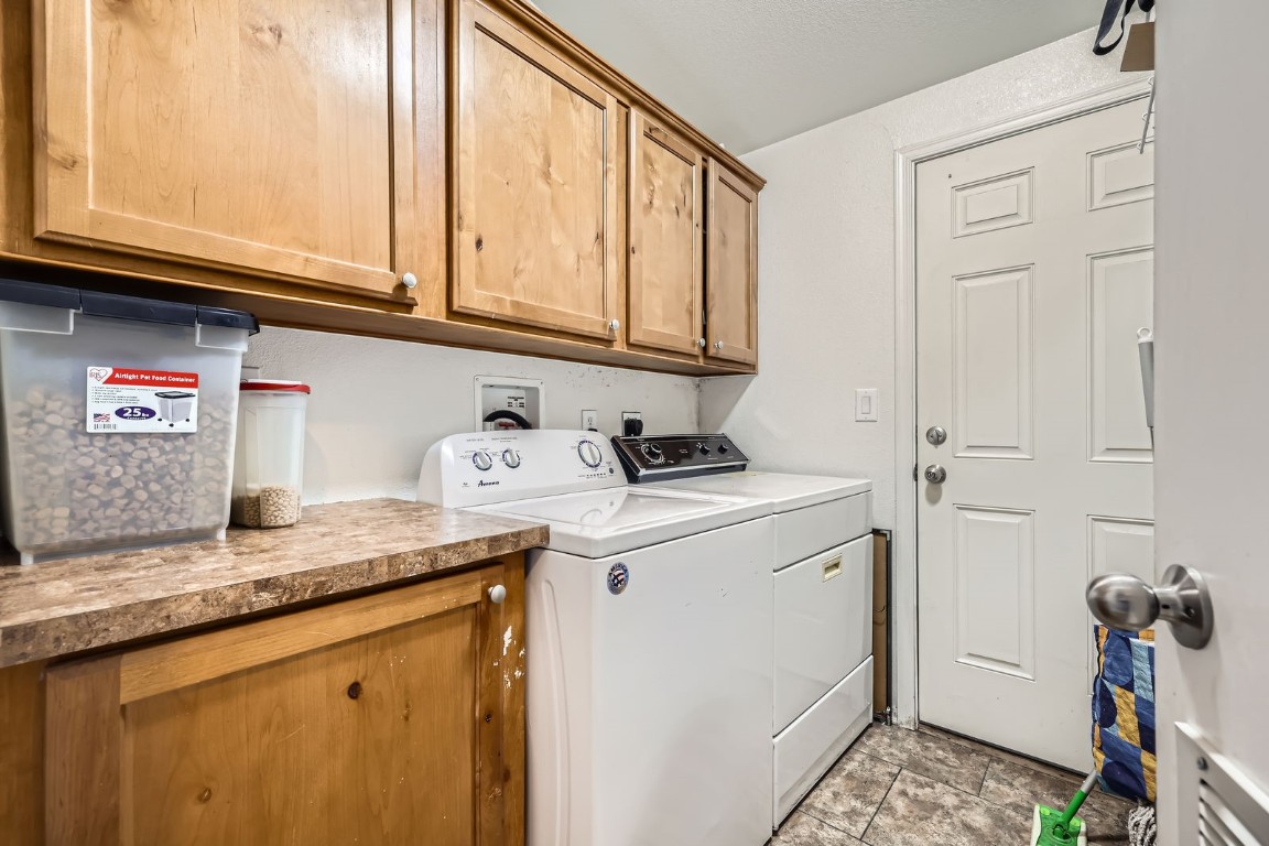 105 Red Cloud Peak Drive Dillon, CO 80435 - Photo 22 of 28 a utility room with granite countertop cabinets washer and dryer