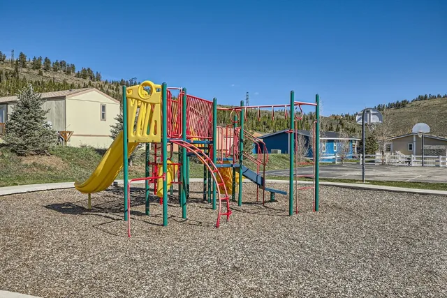 a view of a park with swings and slides