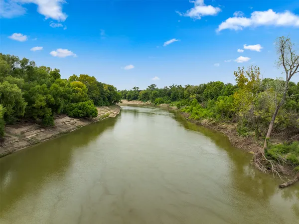 an aerial view of residential houses with outdoor space and swimming pool