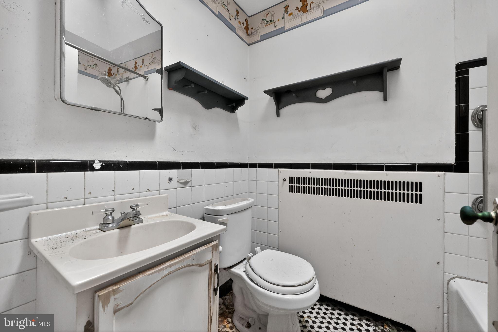 7181 Ruskin Lane Upper Darby, PA 19082 - Photo 15 of 30 a bathroom with a sink toilet and a mirror