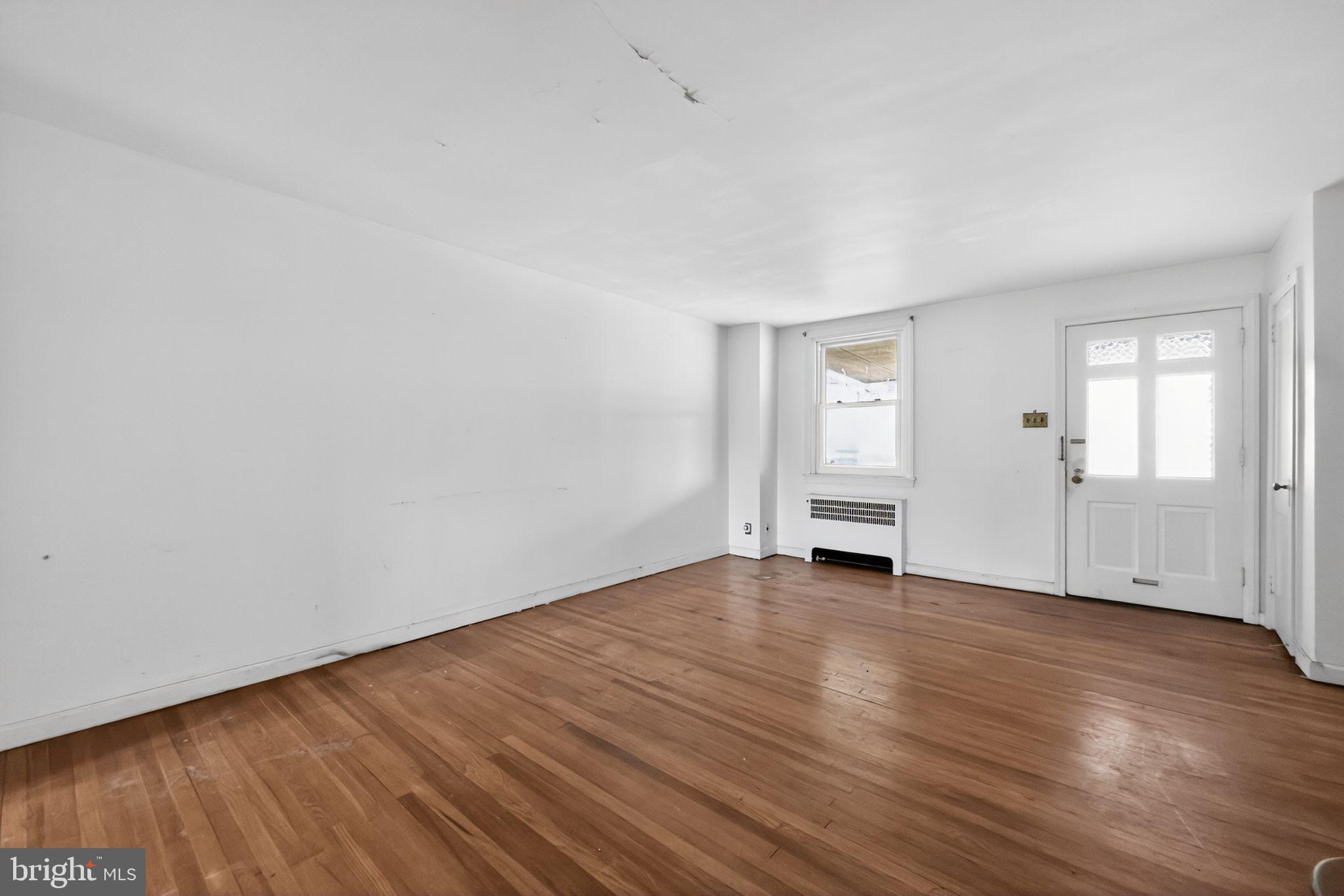 7181 Ruskin Lane Upper Darby, PA 19082 - Photo 3 of 30 a view of empty room with wooden floor and entryway