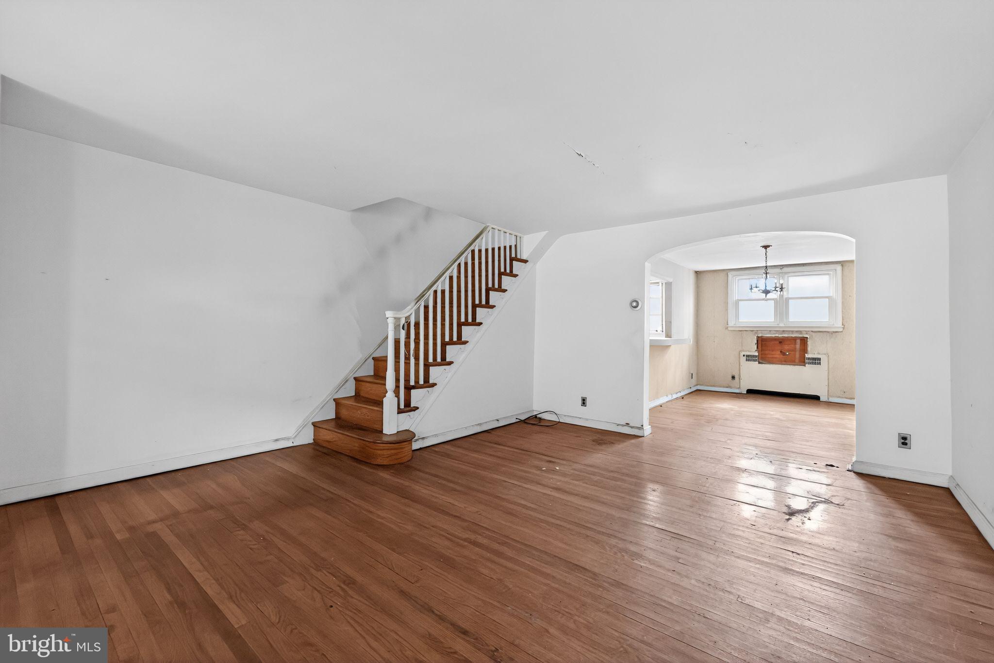 7181 Ruskin Lane Upper Darby, PA 19082 - Photo 4 of 30 a view of an empty room with wooden floor and stairs
