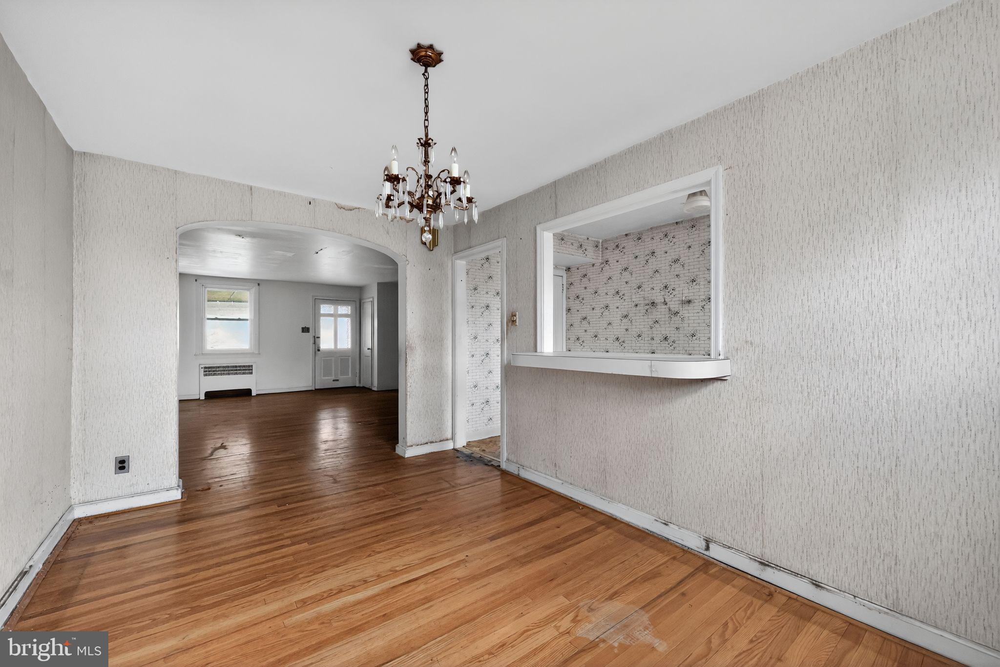 7181 Ruskin Lane Upper Darby, PA 19082 - Photo 6 of 30 a view of a room with wooden floor chandelier and a window