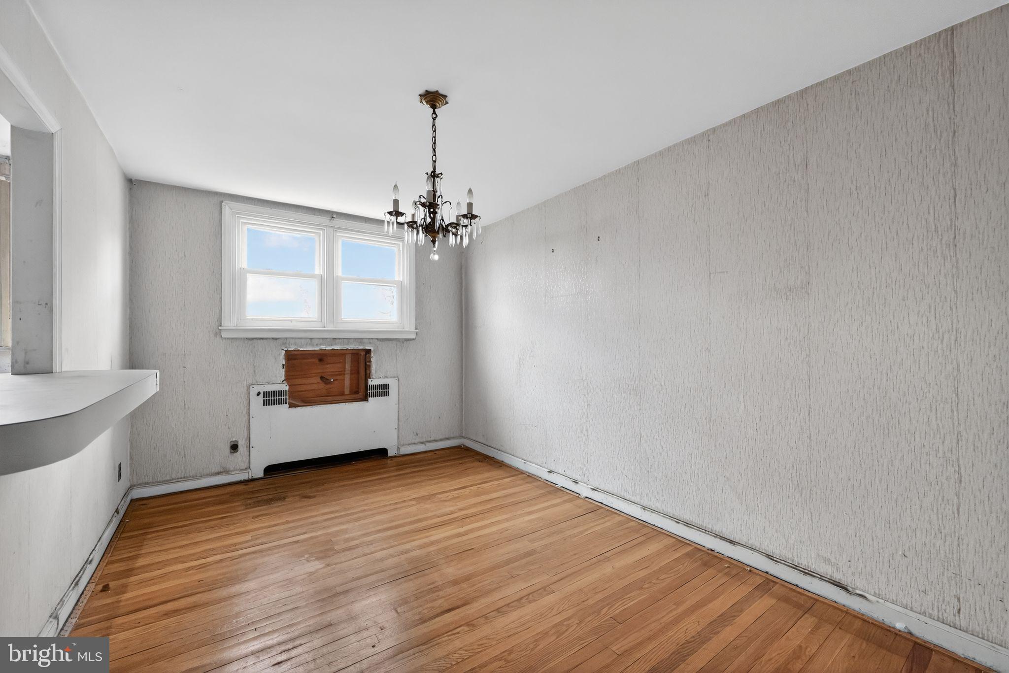 7181 Ruskin Lane Upper Darby, PA 19082 - Photo 7 of 30 a view of an empty room with a window and wooden floor