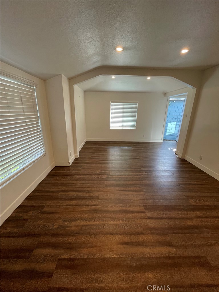 8536 5th Street Downey, CA 90241 - Photo 2 of 13 an empty room with wooden floor and windows