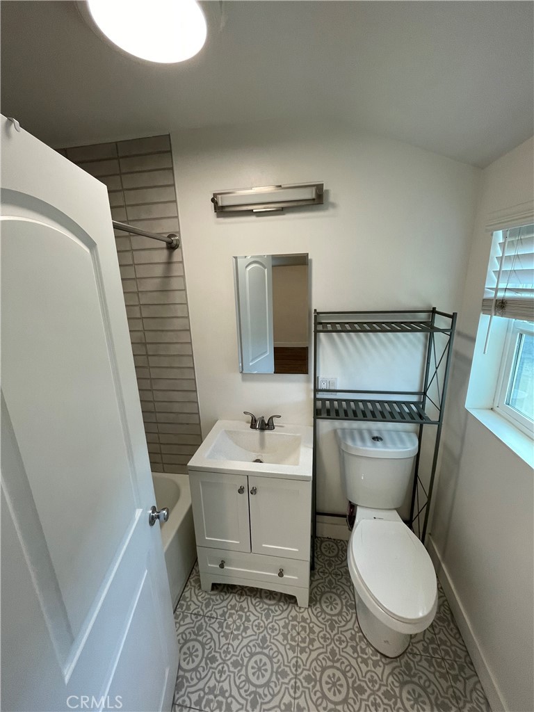 8536 5th Street Downey, CA 90241 - Photo 9 of 13 a bathroom with a toilet sink and mirror