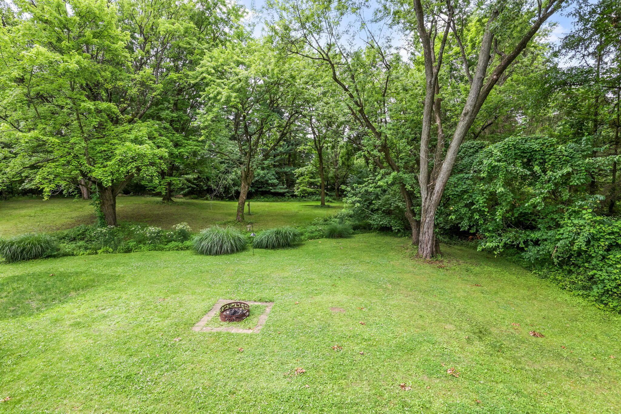 14823 Cleveland Road Southwest Pataskala, OH 43062 - Photo 41 of 57 Expansive lawn featuring mature trees and a built-in fire pit