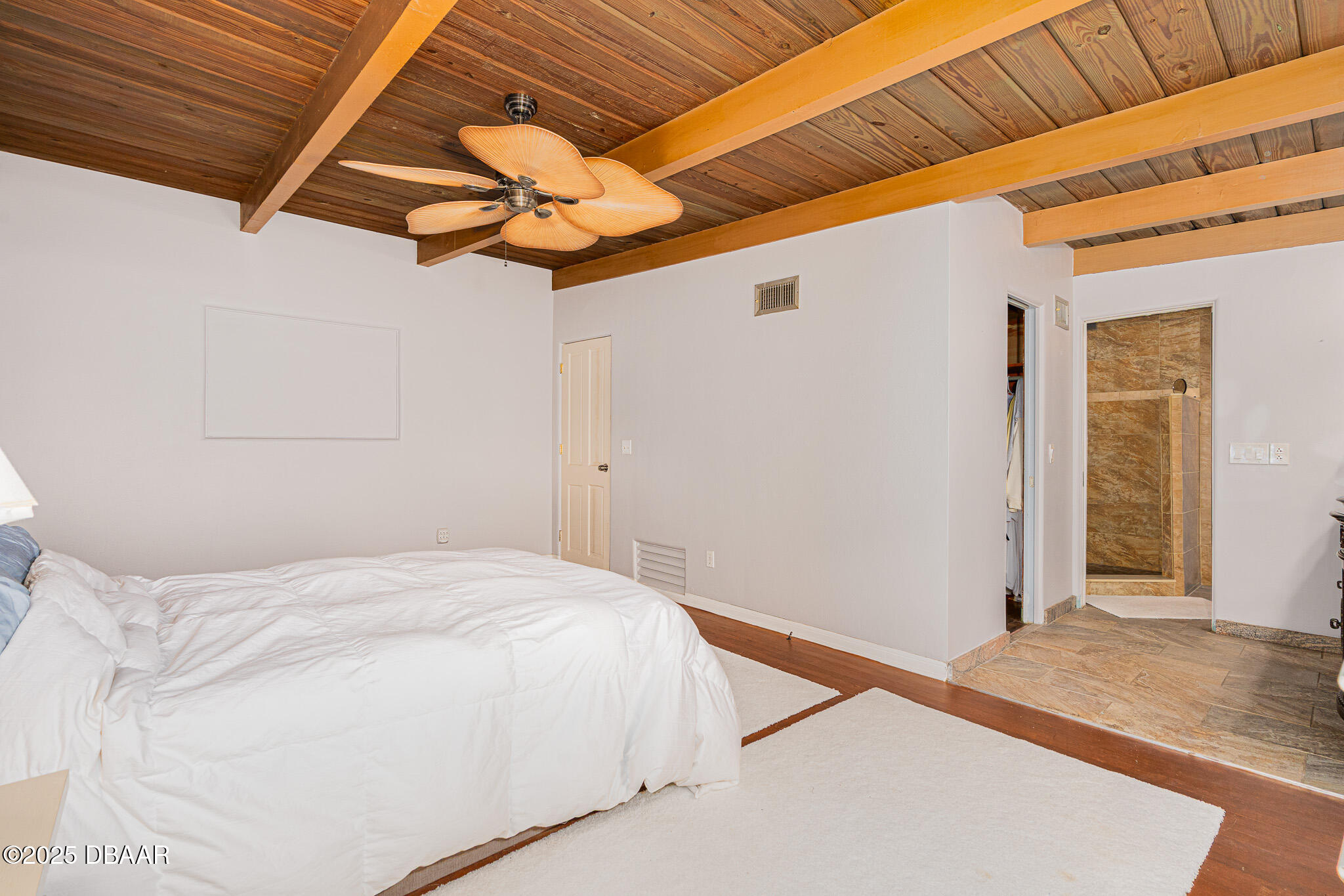 46 Oceanview Avenue Ponce Inlet, FL 32127 - Photo 25 of 79 a bedroom with a bed and a chandelier