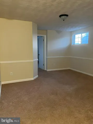 an empty room with a empty space and windows