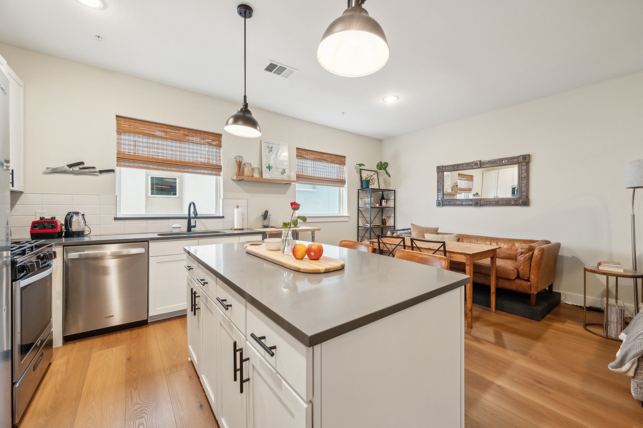 2827 Manor Road, Unit 3104 Austin, TX 78722 - Photo 3 of 30 A well-appointed kitchen features an island, stainless steel appliances, and ample space for dining.
