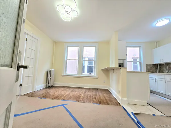 a bedroom with a bed cabinets and a window