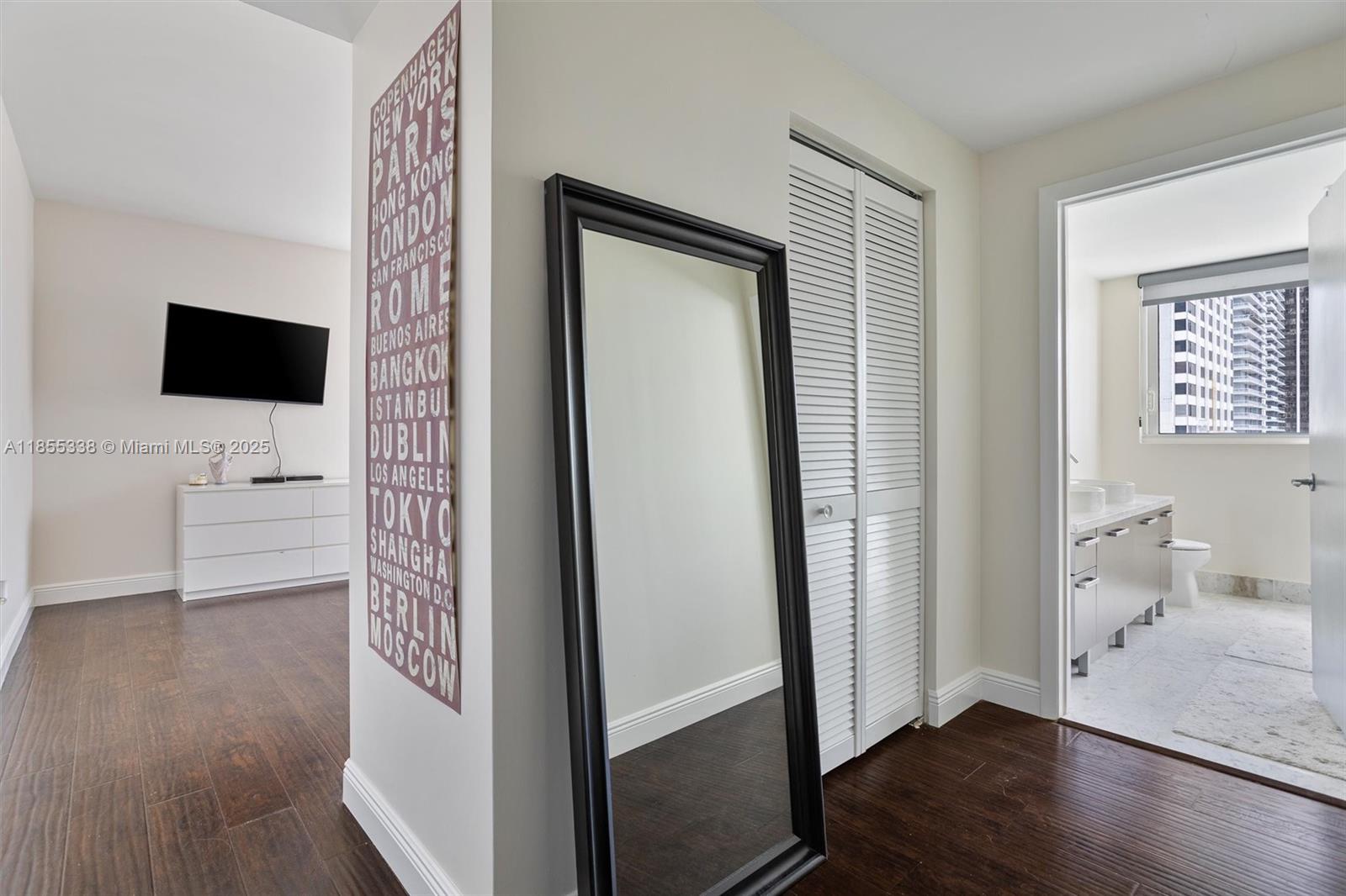 244 Biscayne Boulevard, Unit 1803 Miami, FL 33132 - Photo 19 of 38 a view of a livingroom with wooden floor and a flat screen tv