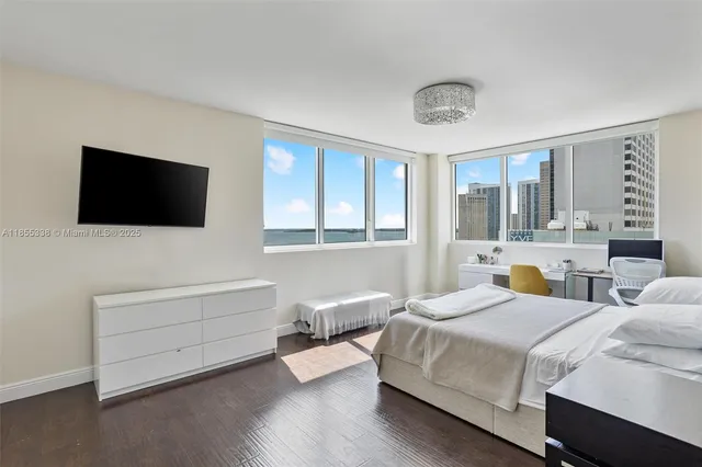 a bedroom with bed and a flat screen tv