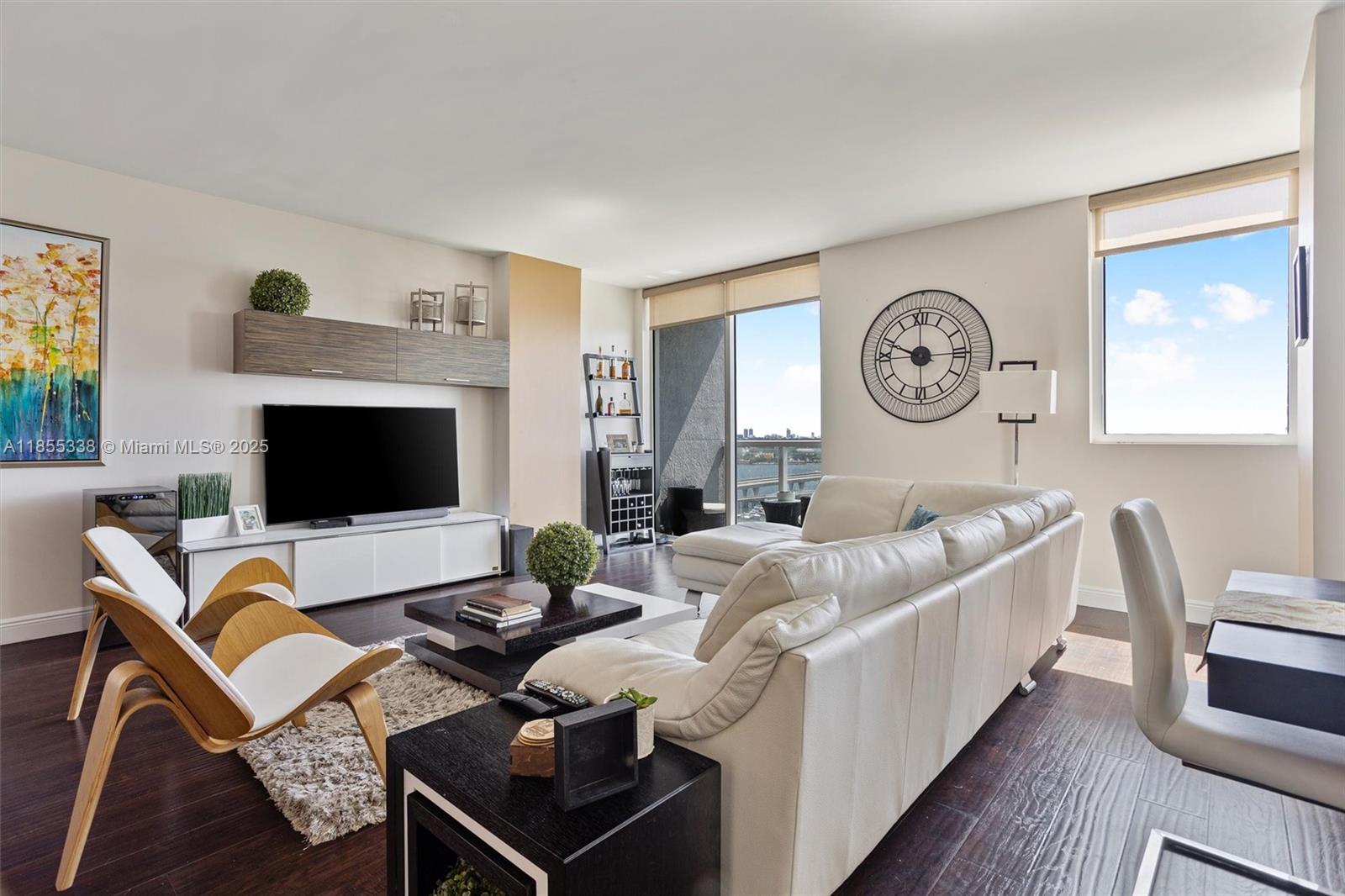 244 Biscayne Boulevard, Unit 1803 Miami, FL 33132 - Photo 2 of 38 a living room with furniture a flat screen tv and a fireplace