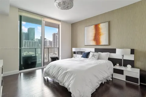 a bedroom with a bed and a large window