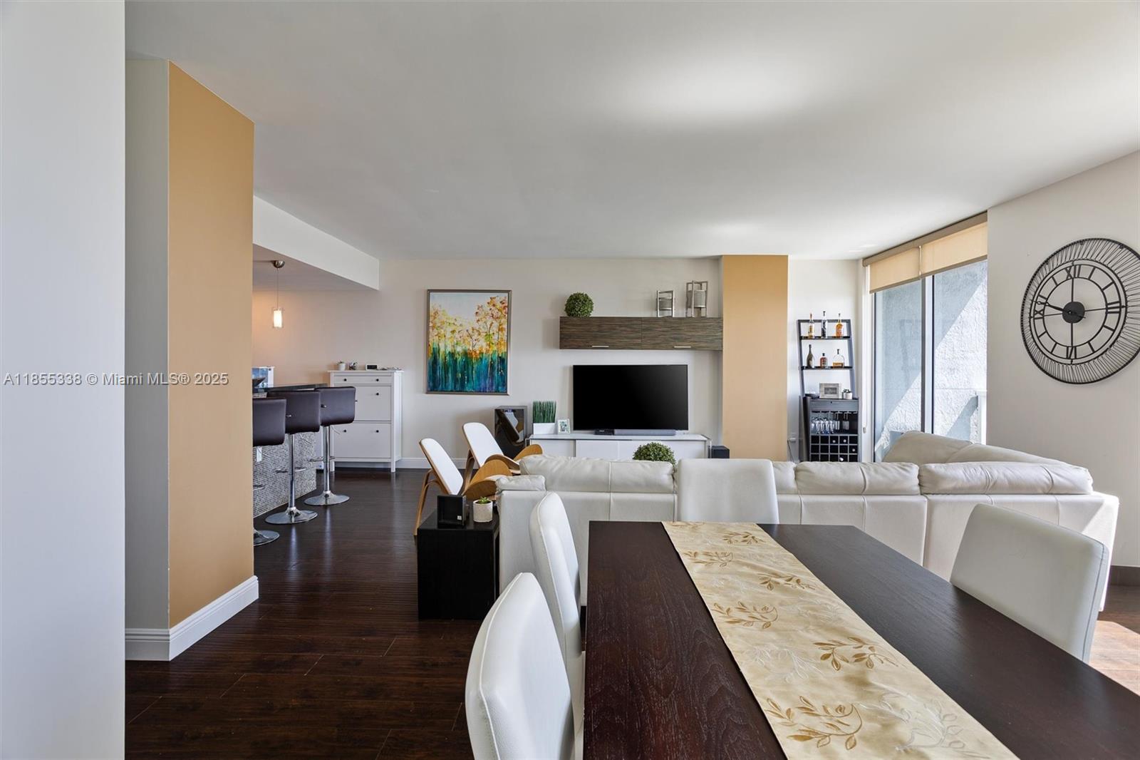 244 Biscayne Boulevard, Unit 1803 Miami, FL 33132 - Photo 4 of 38 a living room with furniture and a flat screen tv