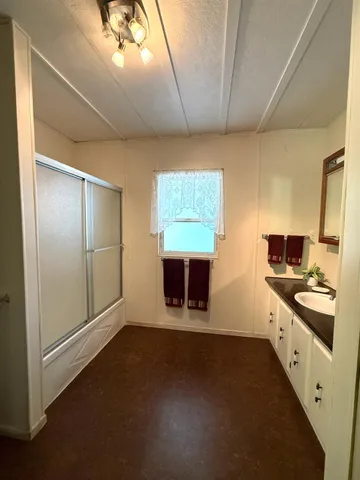 a bathroom with a sink vanity and toilet