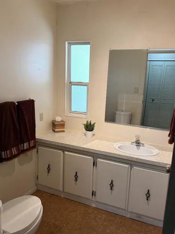 a bed room with a bed and a chair