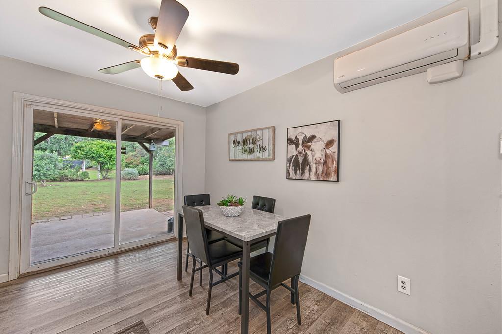6689 Rhodes Avenue Placerville, CA 95667 - Photo 18 of 60 a view of a dining room with furniture a chandelier and wooden floor